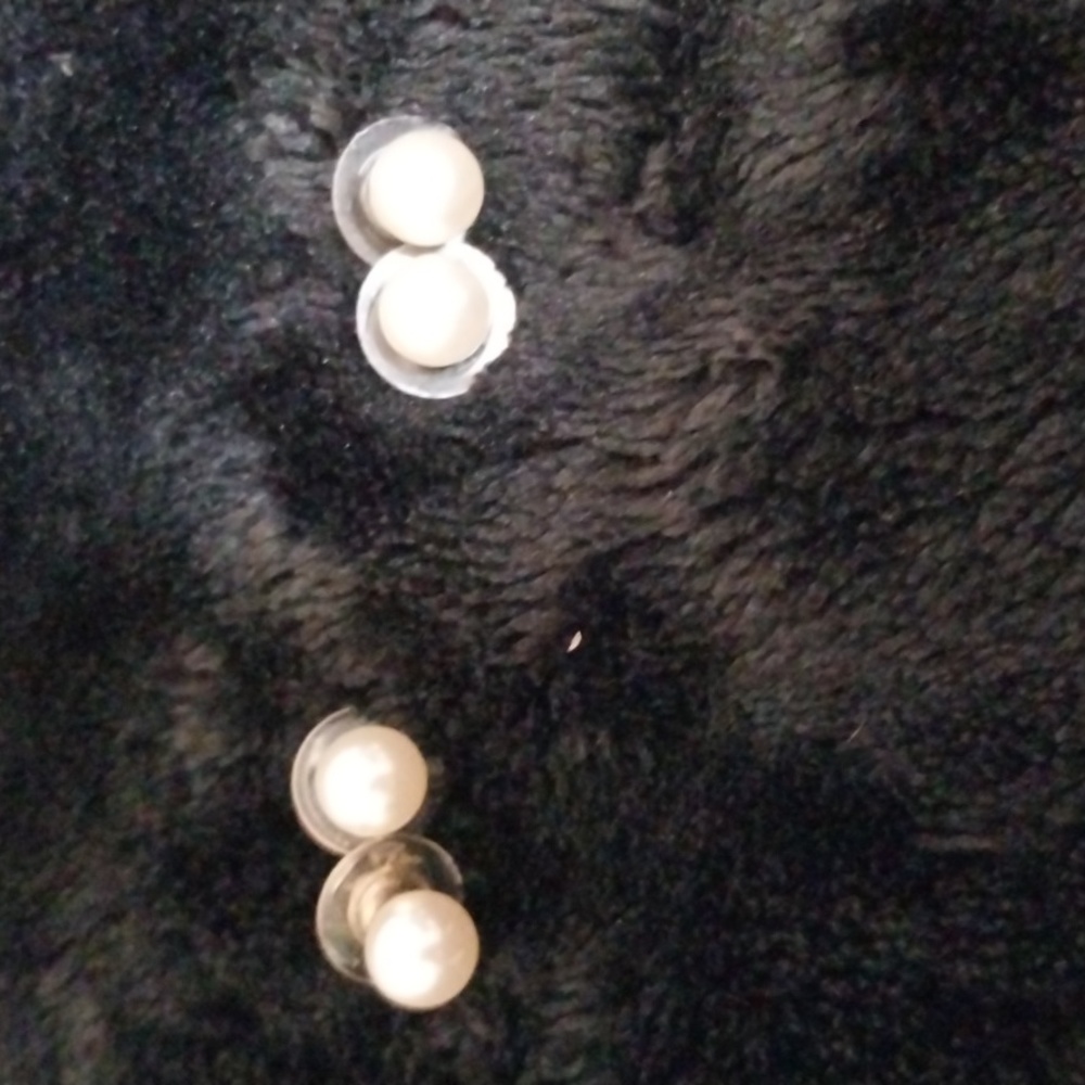 2 sets of pearl earrings. One is white, one slight pink. Silver post. Pierced
